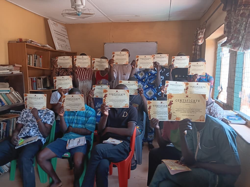 Participants holding up certificates of participation